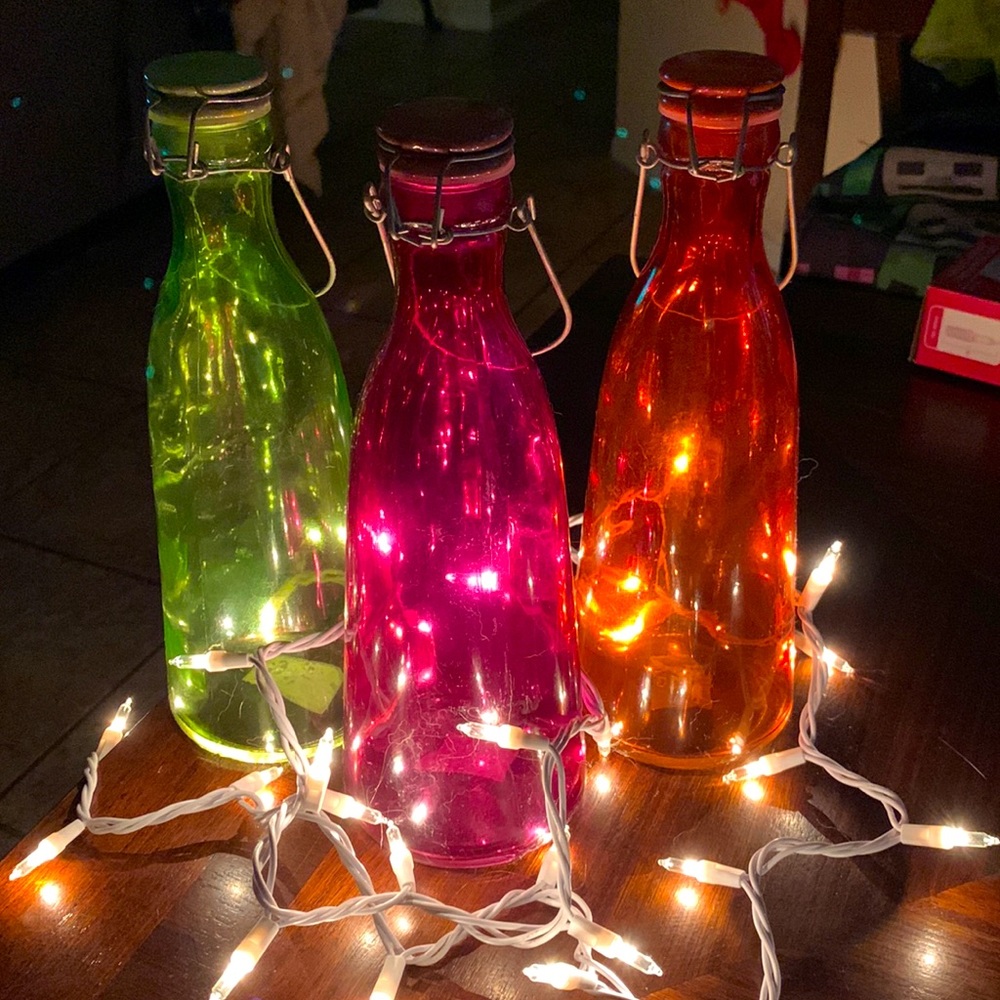 3 purple, green and orange glass bottles not sure of brand
